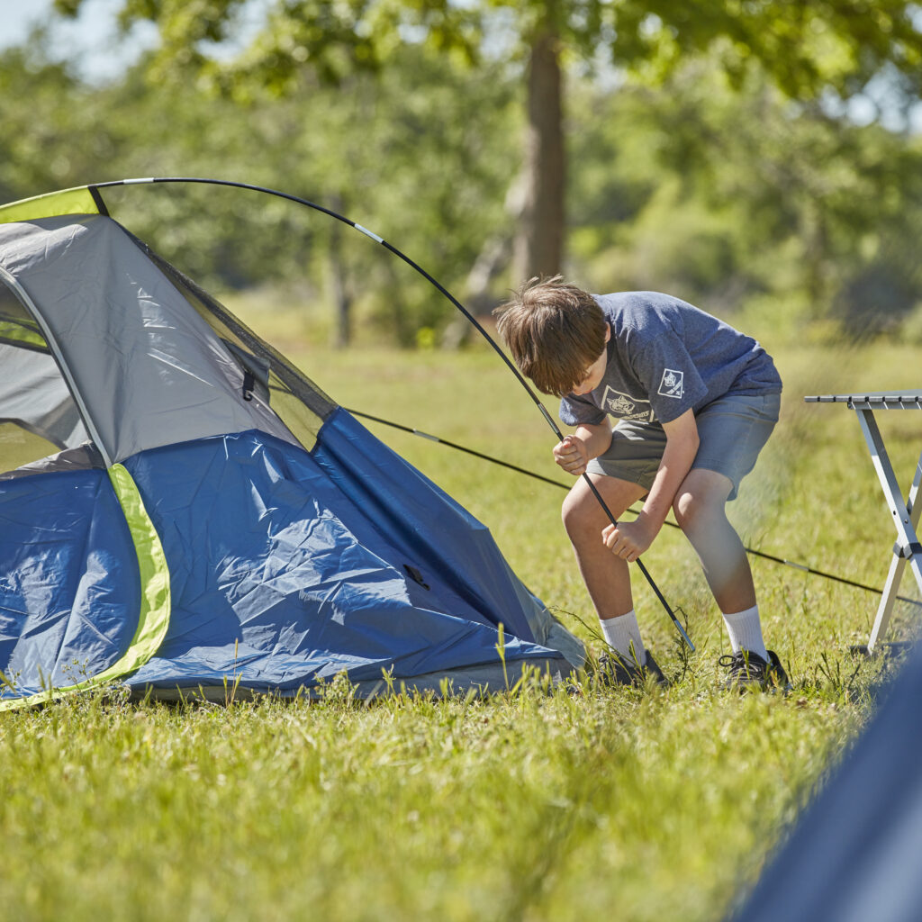 Cub Scout setting up tent